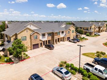 A suburban neighborhood with houses and cars parked in driveways.